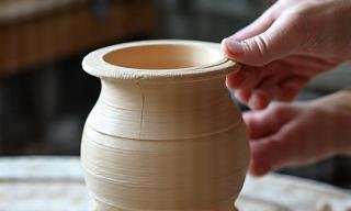 A potter centering clay with focus and precision